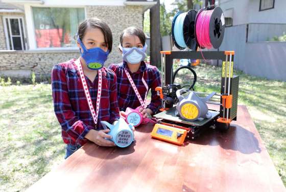 RUTH BONNEVILLE / WINNIPEG FREE PRESSTwin sisters, Ruth Turk (left) and Miriam Turk with the masks they made with their 3D printer for their school science fair project.