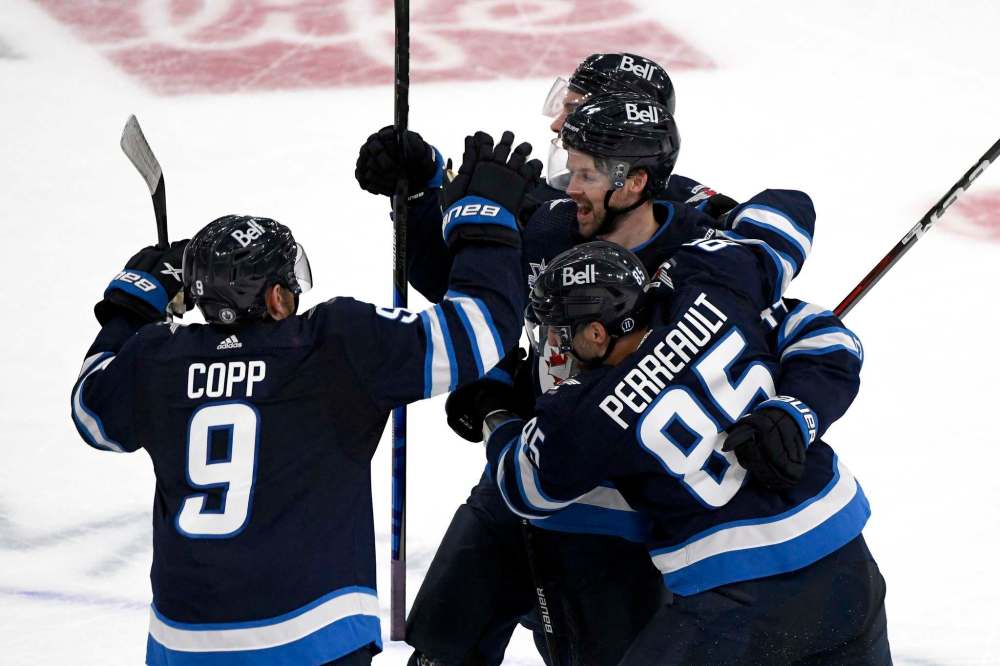 THE CANADIAN PRESS/Fred Greenslade
Josh Morrissey celebrates his third-period goal Sunday with Mathieu Perreault.