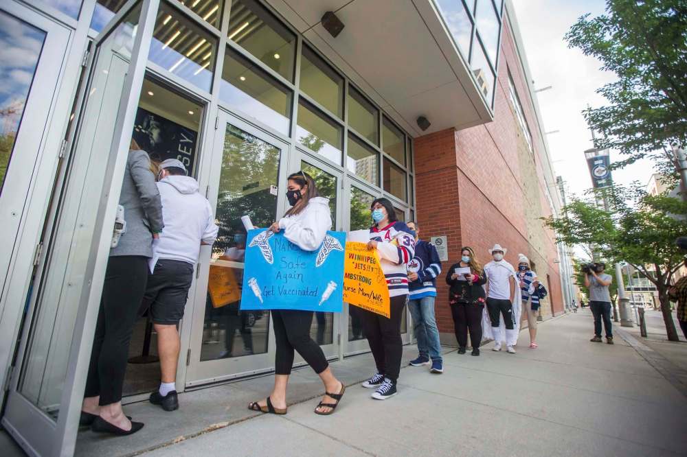 MIKAELA MACKENZIE / WINNIPEG FREE PRESS
Health-care workers wait to enter Bell MTS Place to watch the Jets face the Montreal Canadiens on Wednesday in the first game of their second-round playoff matchup. Five hundred workers were chosen by lottery to attend the game.