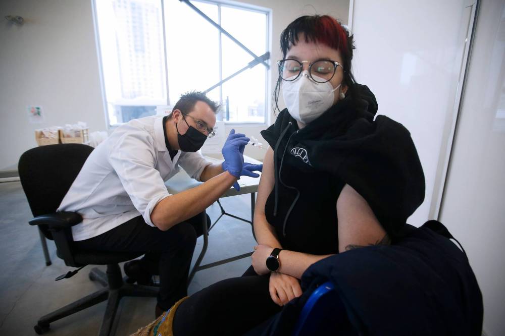 JOHN WOODS / WINNIPEG FREE PRESS Gulowaty vaccinates Emily Bernardin in the vaccine clinic at his pharmacy. Since the spring of 2021, the Osborne clinic has doled out more than 10,000 COVID-19 vaccine doses.