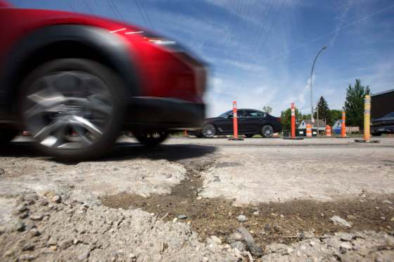 MIKE DEAL / WINNIPEG FREE PRESSCars drive through dips and crumbling road on a stretch of Taylor Ave. near Stafford St.