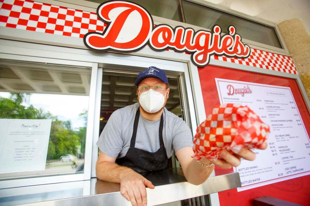 MIKE DEAL / WINNIPEG FREE PRESS
Do you want fries with that?: Chef Grant Danyluk mans the takeout window at Dougie’s.