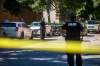 Police investigate the scene of a shooting at Young and Balmoral streets in West Broadway Monday. Mikaela Mackenize / Winnipeg Free Press
