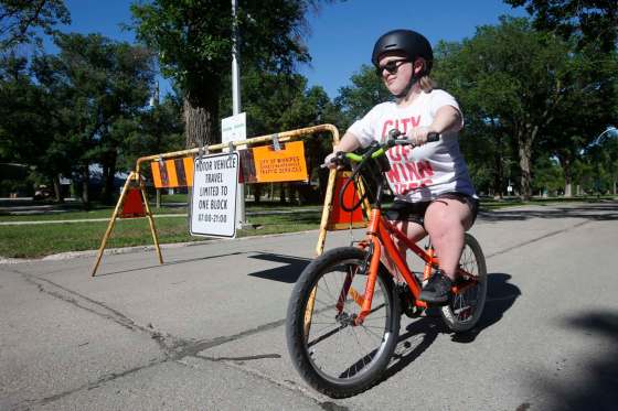 JOHN WOODS / WINNIPEG FREE PRESSSarah Manteuffel says she finds it easier to bike on the open street as a person with a disability. Some residents are complaining that the program is leading to more traffic on Academy Road and prompting confrontations between drivers and pedestrians.