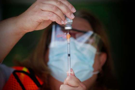 JOHN WOODS / WINNIPEG FREE PRESS Carol Moore, a nurse at St Amant, draws some vaccine at Manitoba’s first drive-in vaccination clinic at St Amant Centre Monday, June 21, 2021. Reporter: Abas