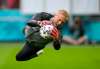Peter Dejong / The Associated Press
Denmark's goalkeeper Kasper Schmeichel dives for the ball Friday during a training session in Amsterdam. Schmeichel's Danes face Wales in the opening game of the Euro 2020 Round of 16.