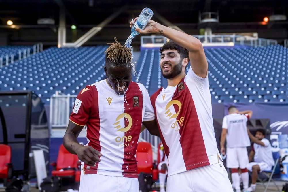 Valour FC's Tony Mikhael (right) dumps water on teammate William Akio after Wednesday's victory over HFX Wanderers. (Robert Reyes Ong / Canadian Premier League)