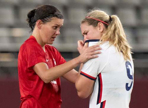 Frank Gunn / The Canadian Press
Team Canada forward Christine Sinclair consoles Team United States midfielder Lindsey Horan after their semifinal match. The two are teammates with the Portland Thorns of the National Women&rsquo;s Soccer League.