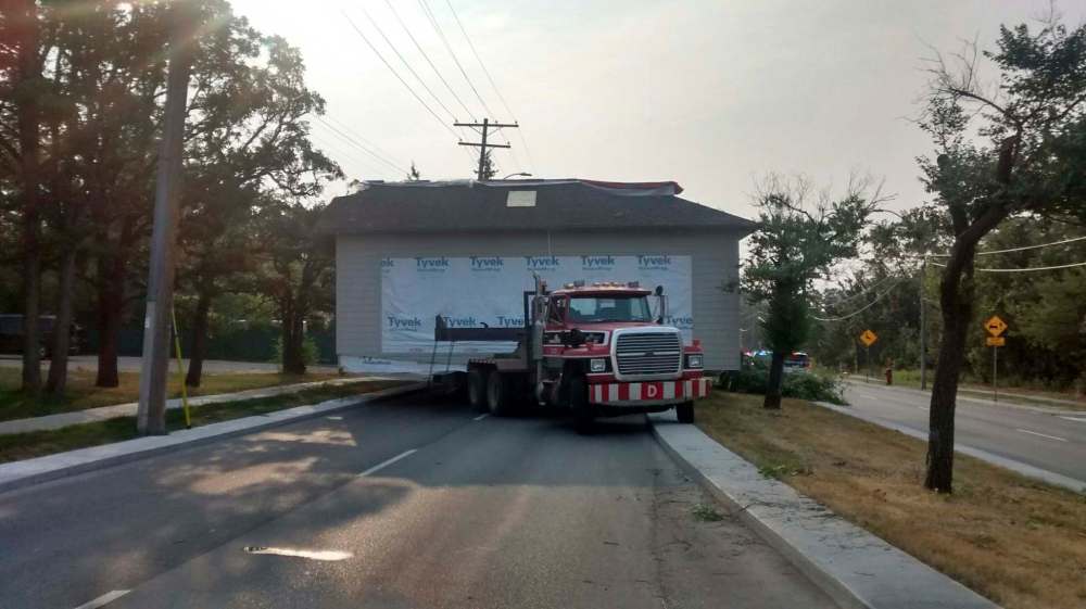 A house being trucked out of the city became stuck on Roblin Boulevard. (Supplied)