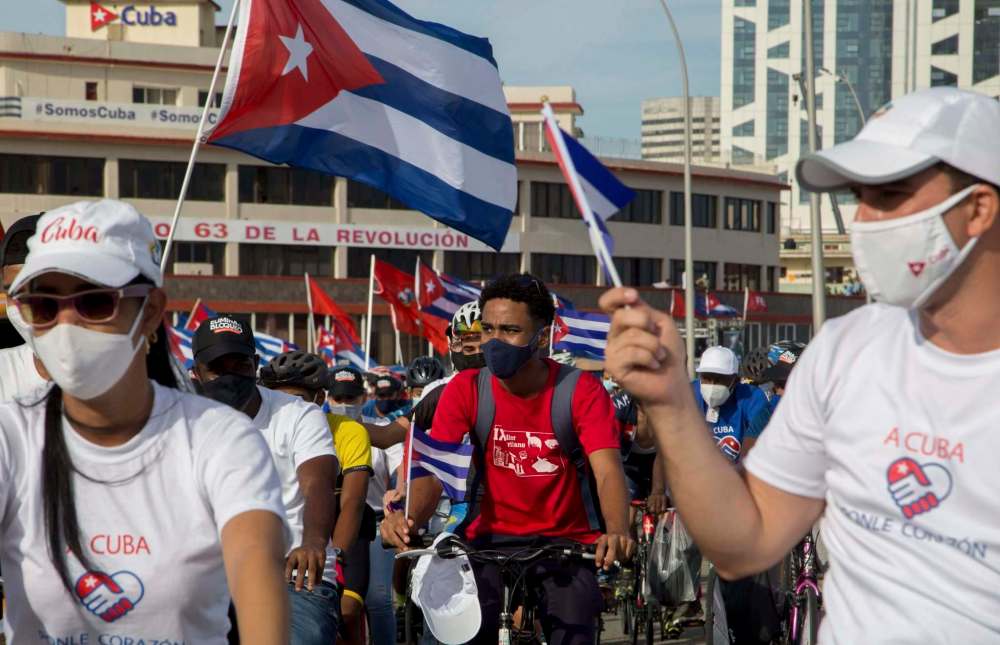 Ismael Francisco / The Associated Press
Government supporters attend a caravan “for love, peace and solidarity,” organized by the Union of Young Communists in Havana on Aug. 5.