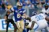 Winnipeg Blue Bombers quarterback Zach Collaros scrambles away from Toronto Argonauts’ Charleston Hughes Friday night at IG Field. (John Woods / The Canadian Press files)