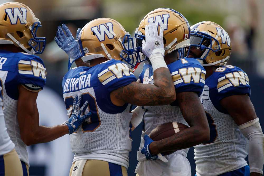 Receiver Darvin Adams (right) scored a TD in his return to the lineup. (Cole Burston / The Canadian Press files)