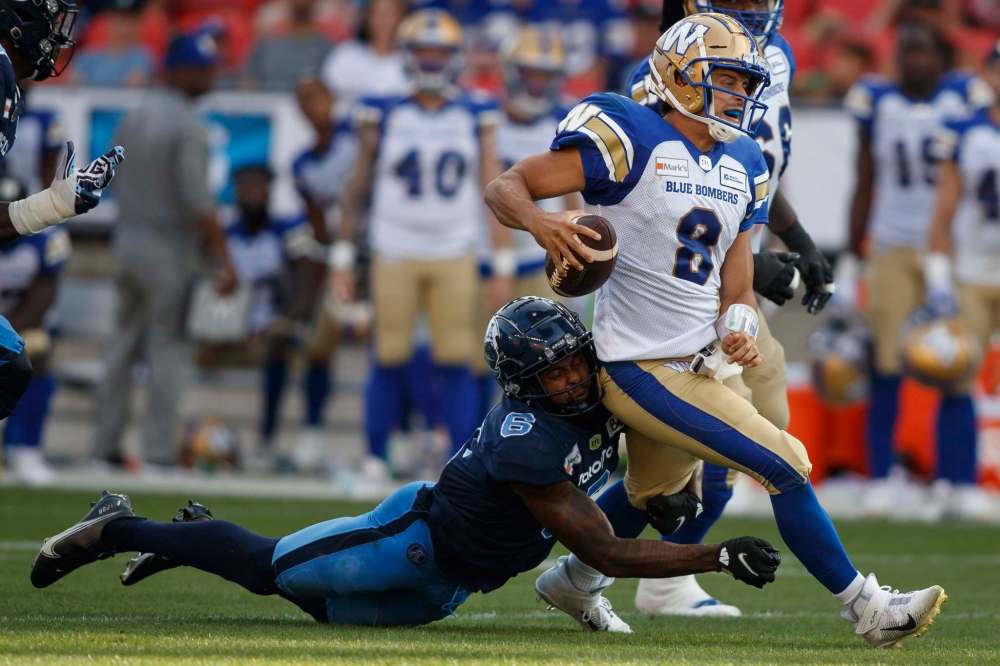 Toronto Argonauts defensive back Chris Edwards brings down Winnipeg Blue Bombers quarterback Zach Collaros Saturday. Collaros and the offence were consistently ineffective. (Cole Burston / The Canadian Press files)