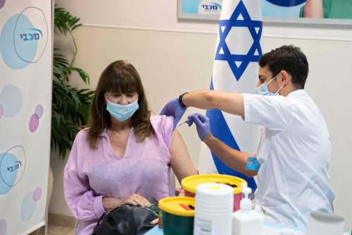 Sebastian Scheiner / The Associated Press Files
An Israel woman receives a Pfizer-BioNTech COVID-19 vaccine in Ramat HaSharon.