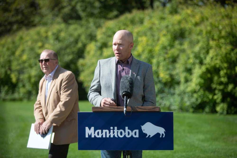 JESSICA LEE / WINNIPEG FREE PRESS
Tyler Fulton (right), president of Manitoba Beef Producers, shown with Agriculture Minister Ralph Eichler, said the drought is forcing producers to make very difficult decisions about how many cattle they can keep based on the feed and water resources they have.
