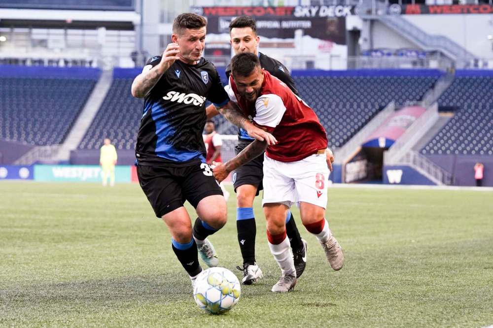Valour’s Keven Alemán (right) battles for the ball with FC Edmonton player Fraser Aird on Tuesday at IG Field. (Robert Reyes Ong / Valour FC)