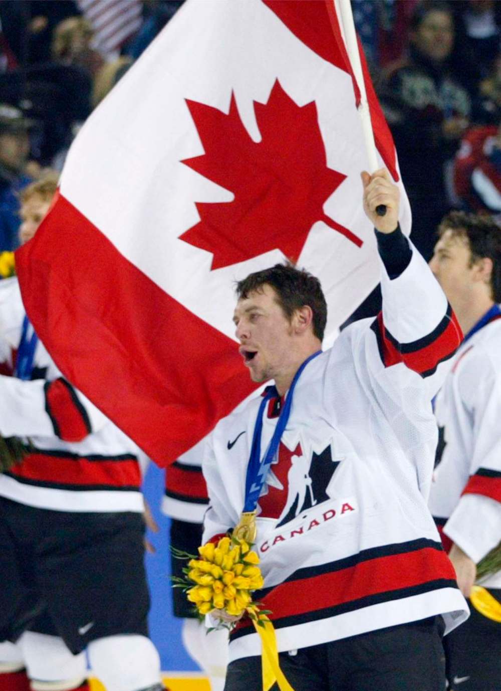 Theo Fleury waves a Canadian flag after winning the gold medal against at the Olympic Winter Games in 2002. (Tom Hanson / The Canadian Press files)