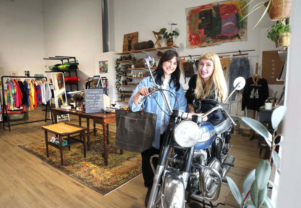 Kristen (right) and Megan in their new boutique store, which features a 1967 Norton Atlas motorcycle. (Ruth Bonneville / Winnipeg Free Press)
