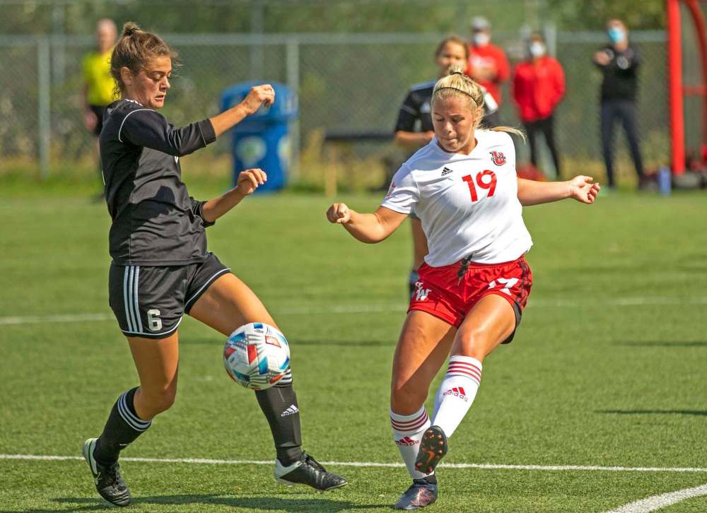 DAVID LARKINS / WESMEN ATHLETICS
University of Winnipeg Wesmen Tori Hauptman (right) fights for the ball with Saskatchewan’s Taryn Iszak at the Waverley Complex over the weekend.