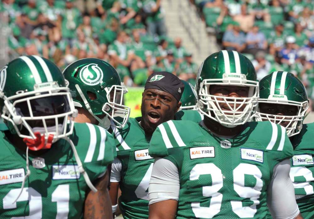 Mark Taylor / The Canadian Press
Roughriders linebacker Derrick Moncrief (centre) celebrates an interception during the Labour Day Classic in Regina.