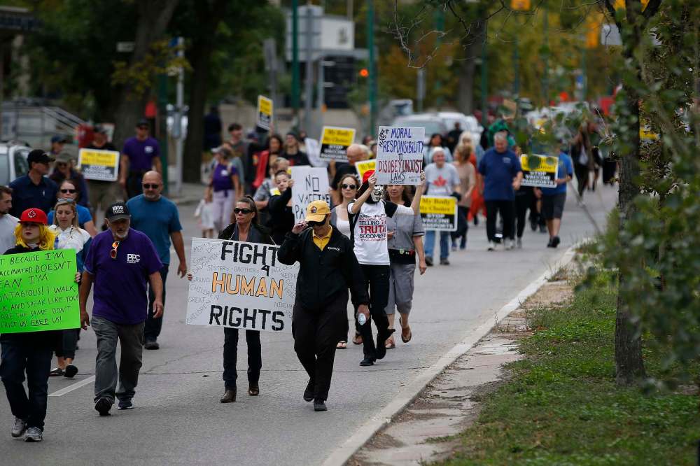 Protesters made their way down Broadway from the legislature on their way to city hall. (John Woods / Winnipeg Free Press)