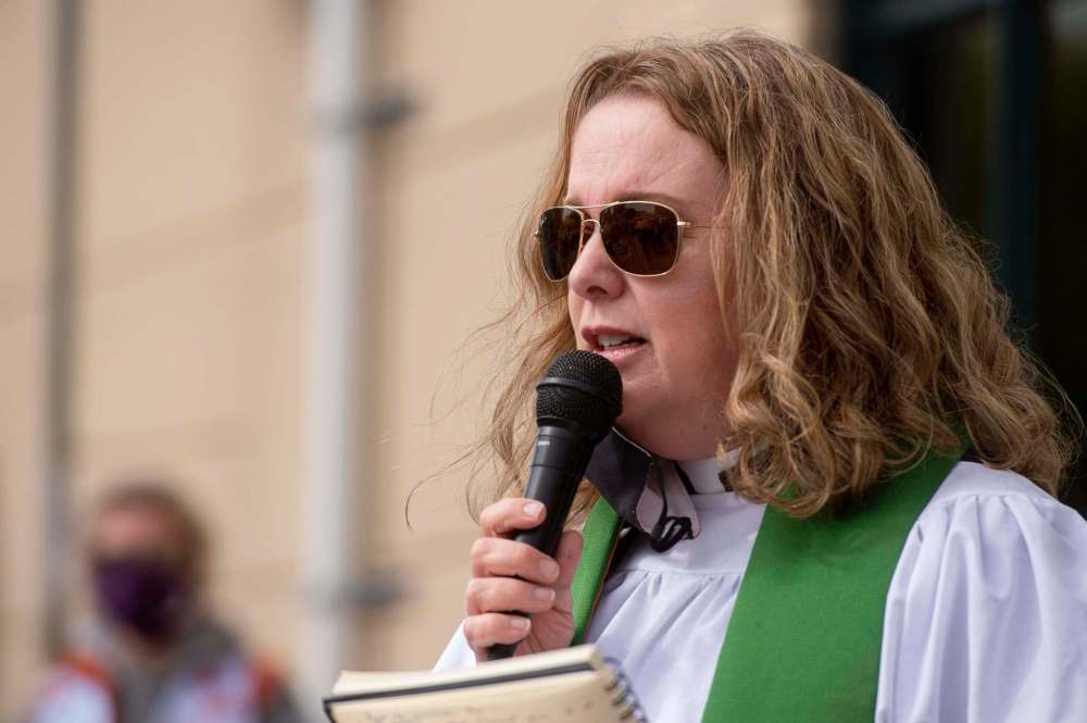 Anglican priest Jane Barter talks to supporters as they take part in communion during the protest. (Mike Sudoma / Winnipeg Free Press)