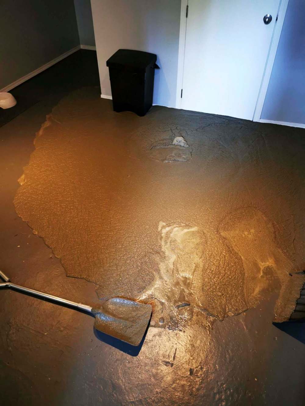 Cement rises out of sewer lines and into Kaitlin Bialek's basement in this May 29, 2021 photo. It is believed to have come from a sewage upgrade by a city contractor.