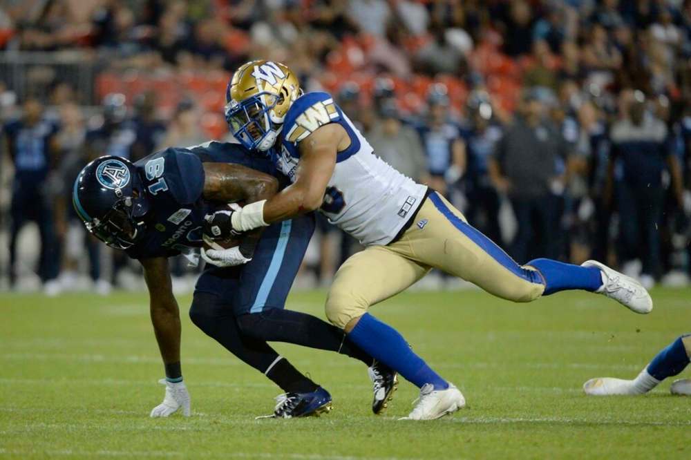 Winnipeg Blue Bombers' defender Kyrie Wilson, right, tackles a Toronto Argonauts receiver in 2019. The 28-year-old linebacker from Fresno, Calif., went down with a hip flexor prior to Week 1 and hasn't played a single snap all season. THE CANADIAN PRESS FILES/Nathan Denette