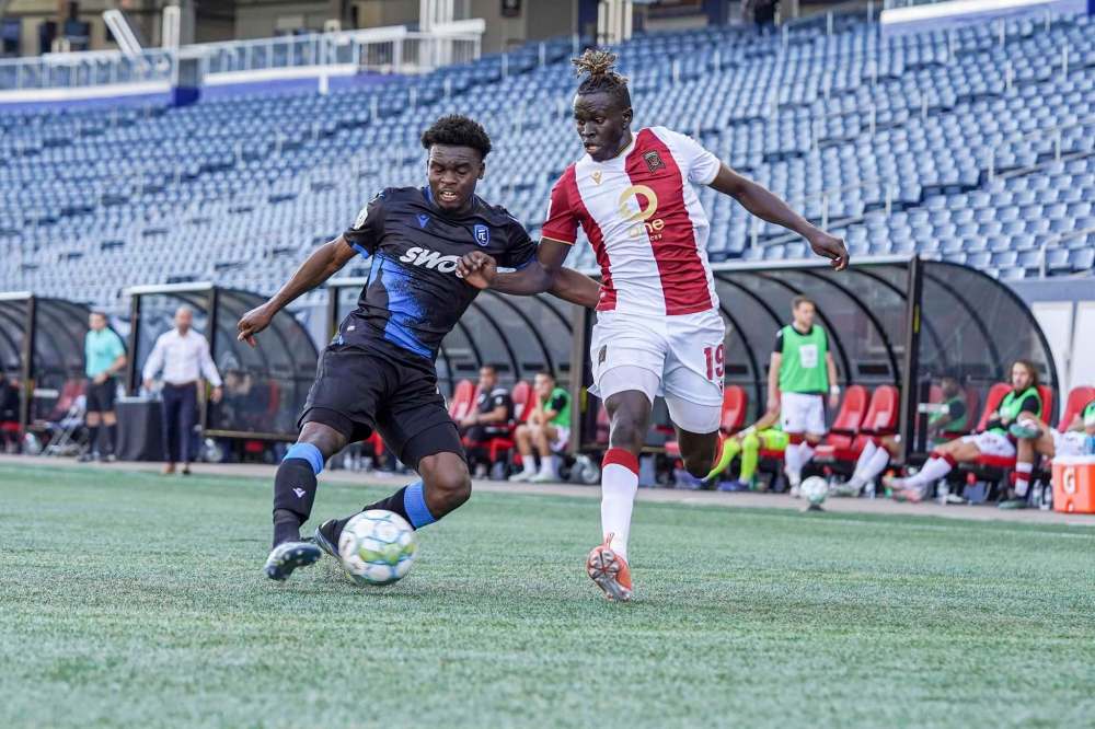 Valour FC's William Akio (right) and FC Edmonton's Saah Fayia challenge for the ball Saturday in Winnipeg. (Robert Reyes Ong / Valour FC)