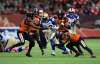 Winnipeg Blue Bombers' Andrew Harris, centre, is tackled by B.C. Lions defenders during the first half in Vancouver, on Friday. THE CANADIAN PRESS/Darryl Dyck