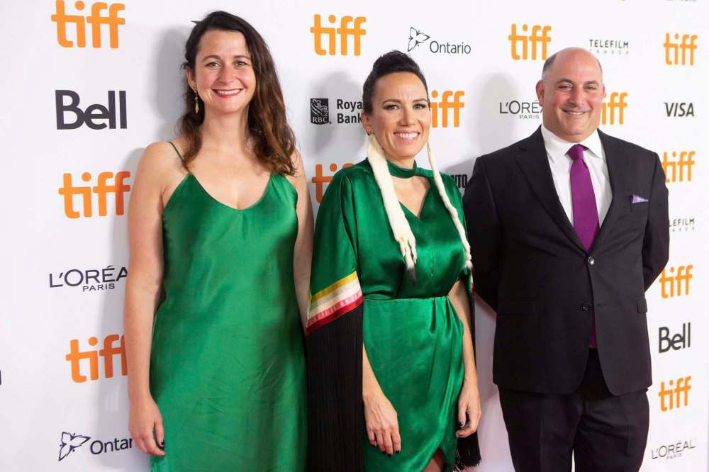 Chris Young / The Canadian Press Files
Night Raiders director Danis Goulet (centre) stands with producers Tara Woodbury (left) and Paul Barkin on the TIFF red carpet.