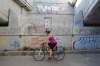 JESSICA LEE / WINNIPEG FREE PRESS
A woman bikes past a sign under the Norwood Bridge which says no camping and no fires.