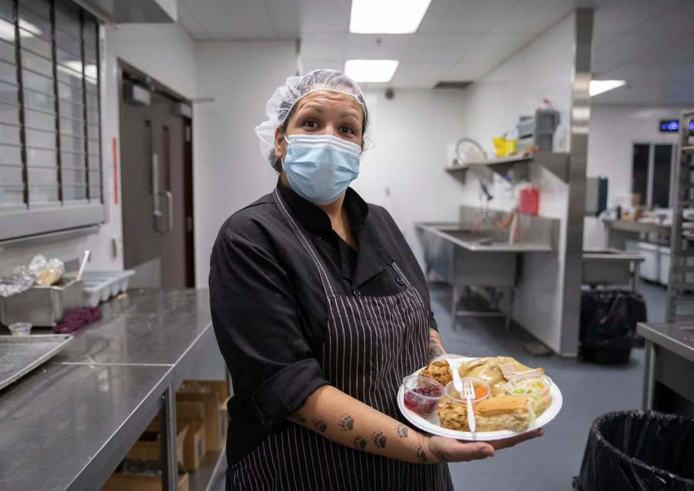 Sonja Lavallee with a plate of food served to community members on Friday. (Jessica Lee / Winnipeg Free Press)