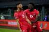 Canada's Jonathan Osorio (left) celebrates a goal against Mexico on Thursday during a qualifying soccer match for the 2022 World Cup. (Fernando Llano / The Associated Press)