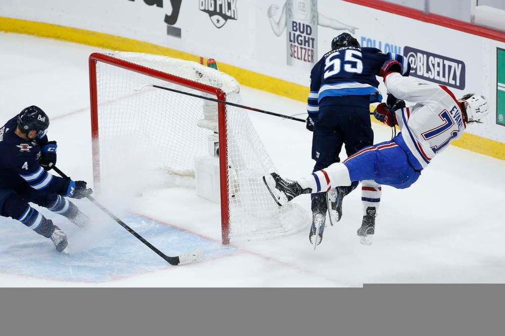 Mark Scheifele was suspended for this hit on Jake Evans after the Montreal player scored an empty net goal during their first playoff game. (John Woods / The Canadian Press files)
