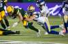 Winnipeg Blue Bombers’ Jesse Briggs tackles Edmonton Elks’ Greg Ellingson Friday night in Edmonton. The Bombers clinched a playoff spot with a shaky victory. (Jason Franson / The Canadian Press files)