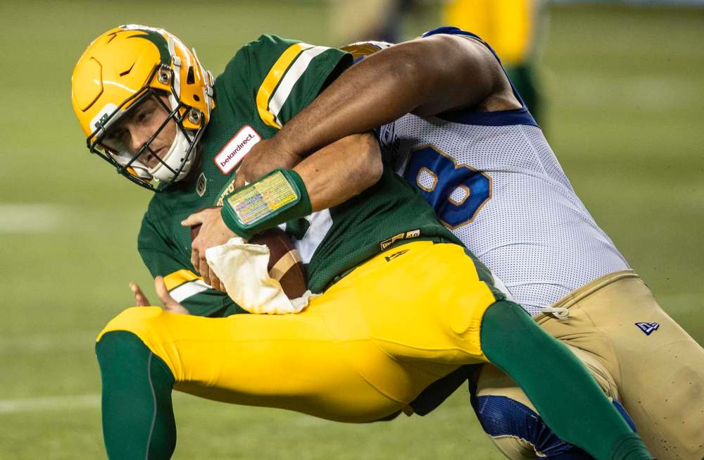 Steven Richardson sacks Elks quarterback Taylor Cornelius in the first half. (Jason Franson / The Canadian Press)