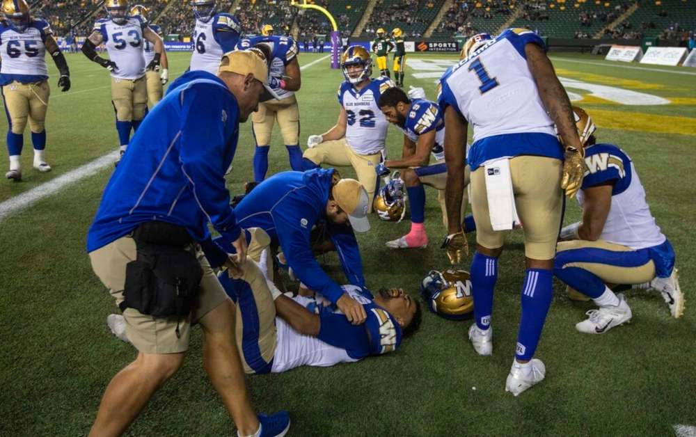 Winnipeg Blue Bombers' Andrew Harris was injured after scoring a touchdown against the Edmonton Elks during the first half in Edmonton on Friday. THE CANADIAN PRESS/Jason Franson.