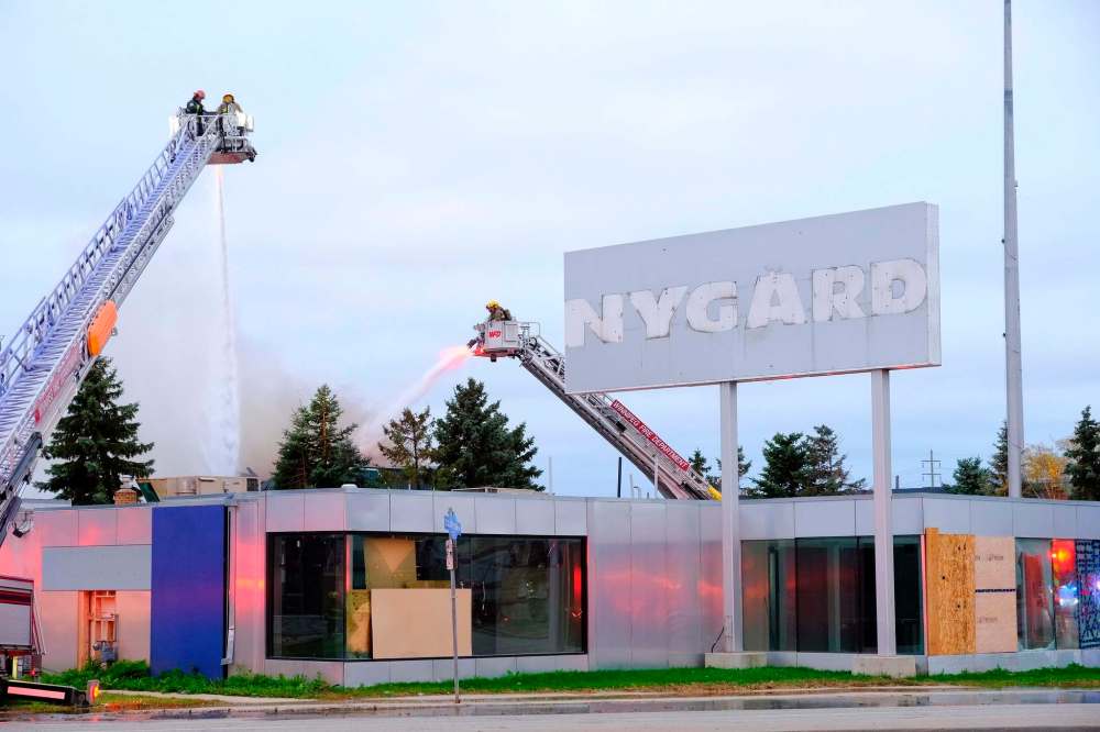Crews were on scene Tuesday morning at 1340 Notre Dame Ave. working to extinguish a fire at Peter Nygard's former warehouse. (Mike Deal / Winnipeg Free Press)