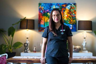 Registered nurse April Intertas began nursing in her homeland, the Philippines, and is one of many Filipinas and Filipinos caring for patients in Manitoba hospitals. (Mikaela MacKenzie / Winnipeg Free Press)