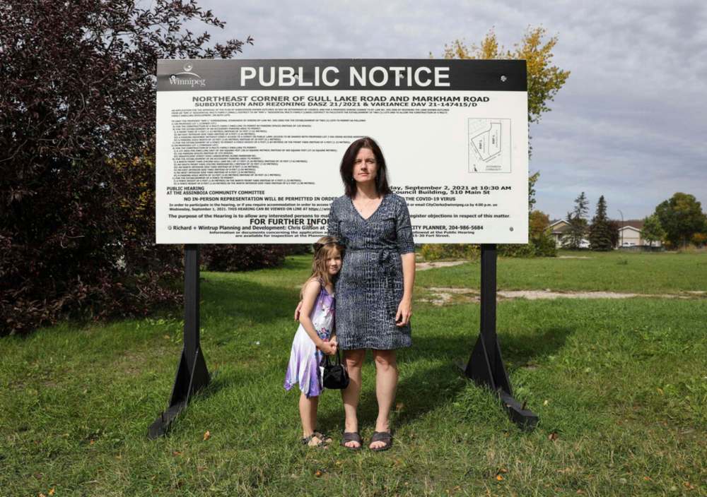 JESSICA LEE / WINNIPEG FREE PRESS FILES
Audrey VanderSpek, with daughter Lara, at the corner of Gull Lake Road and Markham Road where a new residential development is being planned. VanderSpek opposes the development, saying it is too high and will cast a shadow on nearby residential properties.