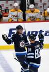 Nate Schmidt (right) wants to see the Jets build on their two wins. (Fred Greenslade / The Canadian Press files)