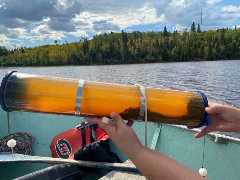A water sample taken in August from Camp Lake shows high amounts of iron from a former mine which turns the water dark orange. Other metals that are toxic are raising concern about the fish local Métis rely on. (Courtesy of Manitoba Metis Federation)