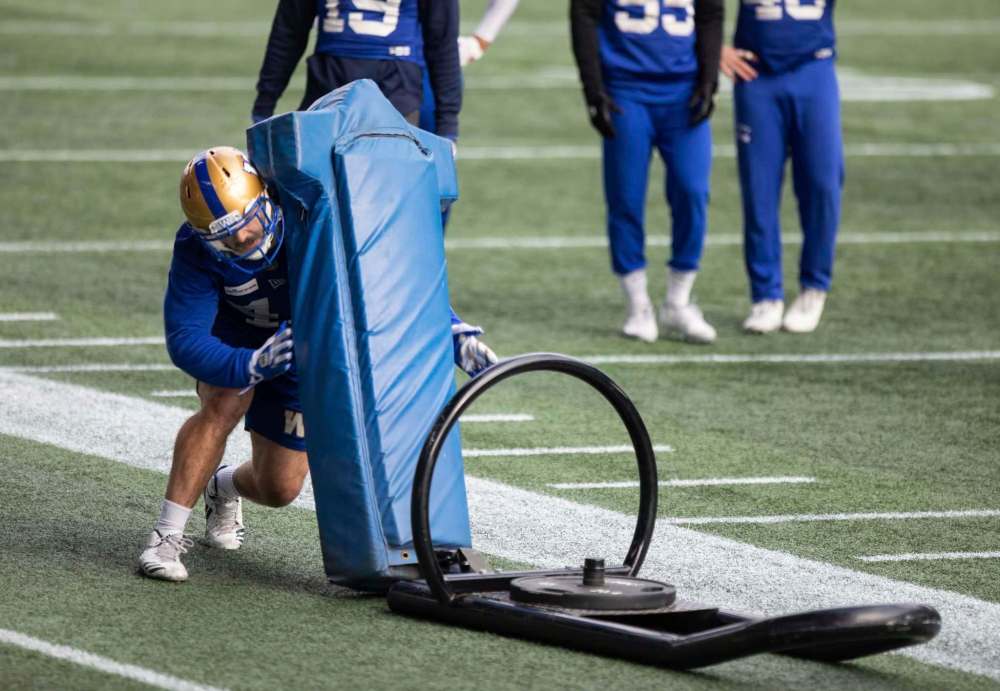 JESSICA LEE / WINNIPEG FREE PRESS
Tanner Cadwallader of the Winnipeg Blue Bombers takes on a blocking sled at practice.