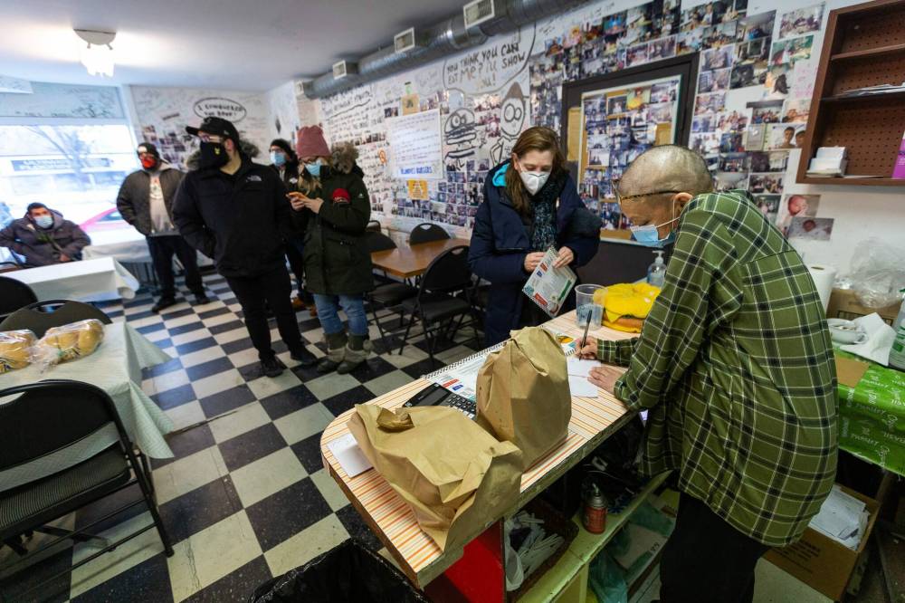 Doyle and her friend Kim, who was working the counter, were handing out tickets and took advance orders so would-be customers didn’t have to wait on the street in the cold wind. (Daniel Crump / Winnipeg Free Press)