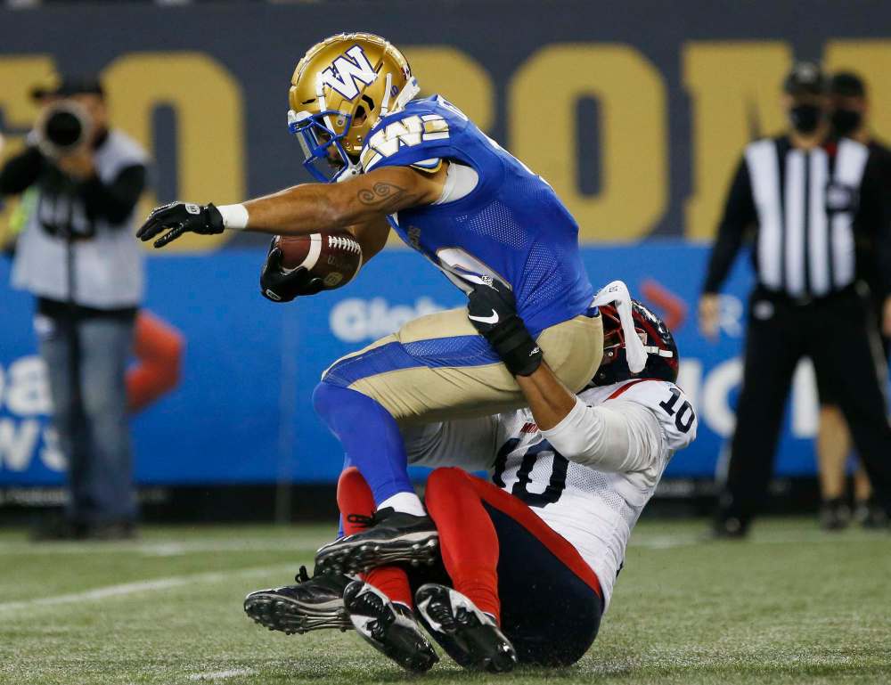 Winnipeg Blue Bombers' Nic Demski (10) gets tackled by Montreal Alouettes' Nick Usher (10) during the second half. (John Woods / The Canadian Press)