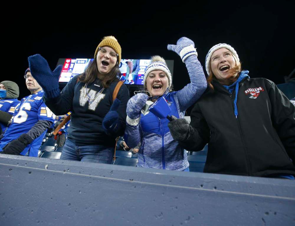 Winnipeg Blue Bombers fans celebrate a win over the Montreal Alouettes. (John Woods / The Canadian Press)