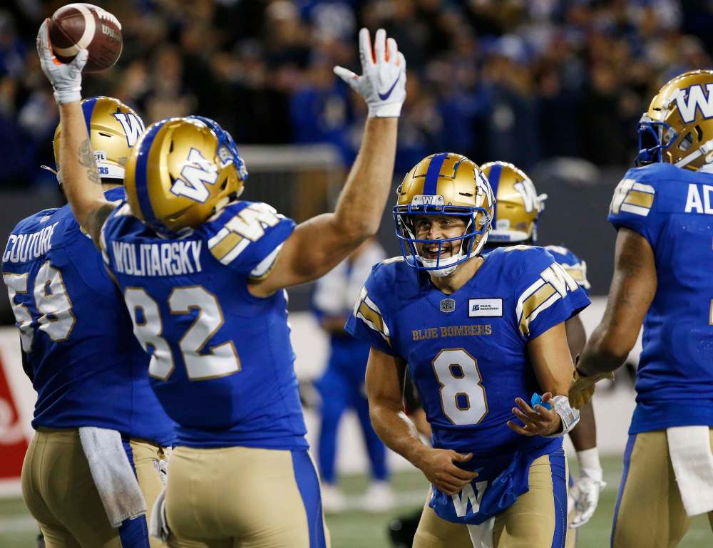 Winnipeg Blue Bombers' Drew Wolitarsky (82) and quarterback Zach Collaros (8) celebrate Wolitarsky’s touchdown against the Montreal Alouettes during the second half. (John Woods / The Canadian Press)