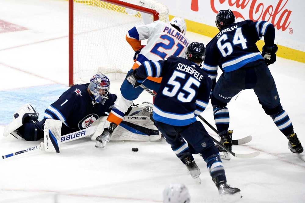Winnipeg Jets goaltender Eric Comrie was in fine form against the Islanders Saturday night. Mark Scheifele might not be scoring, but he’s backchecking. (Fred Greenslade / The Canadian Press files)