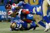 Winnipeg Blue Bombers linebacker Adam Bighill (top) tackles Montreal Alouettes’ Cameron Artis-Payne Saturday night at IG Field. The Blue won their 11th game of the season and their ninth in a row. (John Woods / The Canadian Press files)